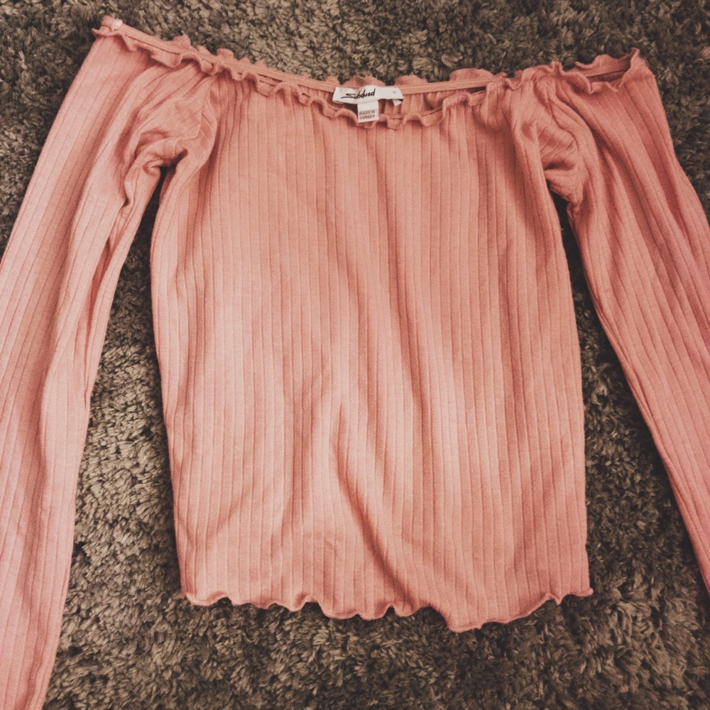 A pink off the shoulder ribbed shirt.
